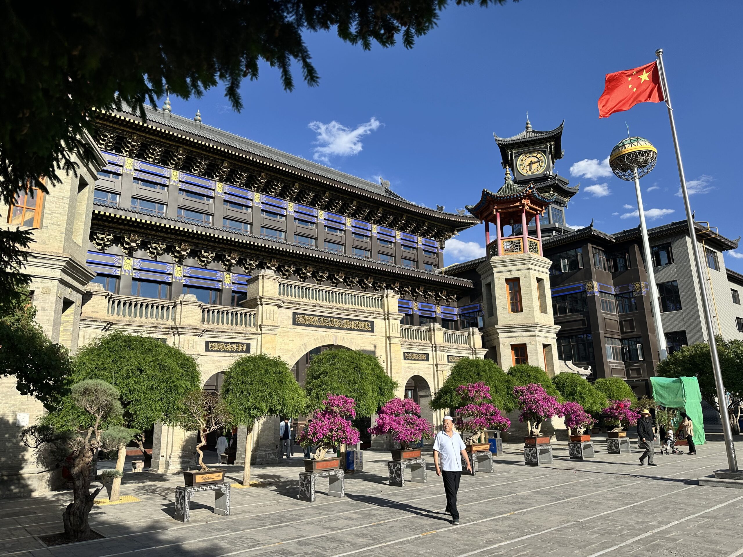 Renovated courtyard buildings at Dongguan Mosque in Xining beneath a clear blue sky