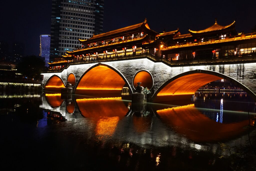 Illuminated Anshun Bridge arches reflected in Chengdu's Jin River at night