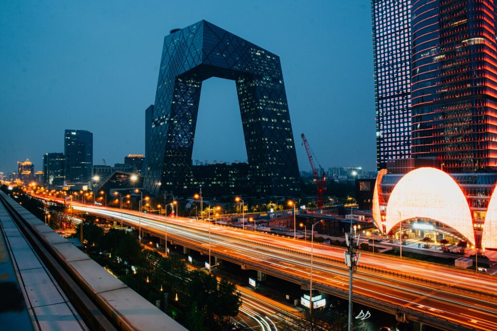 Beijing skyline at night with the CCTV Headquarters and illuminated highways