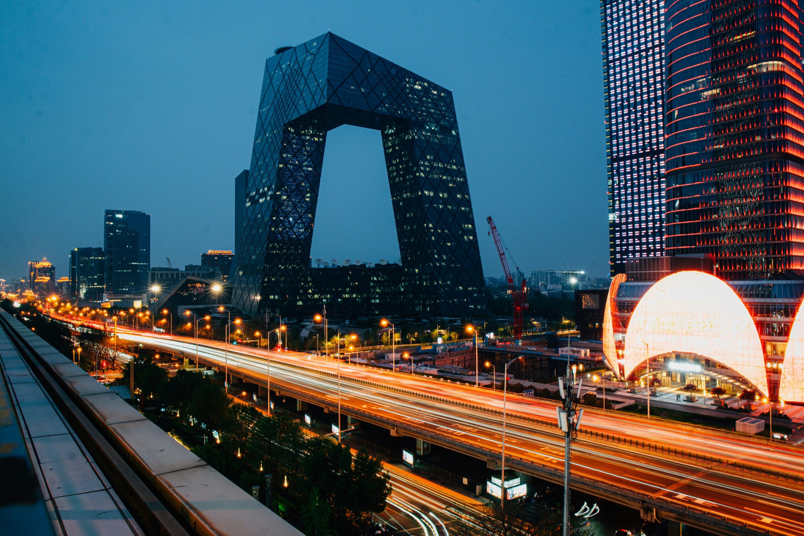 Beijing skyline at night with the CCTV Headquarters and illuminated highways