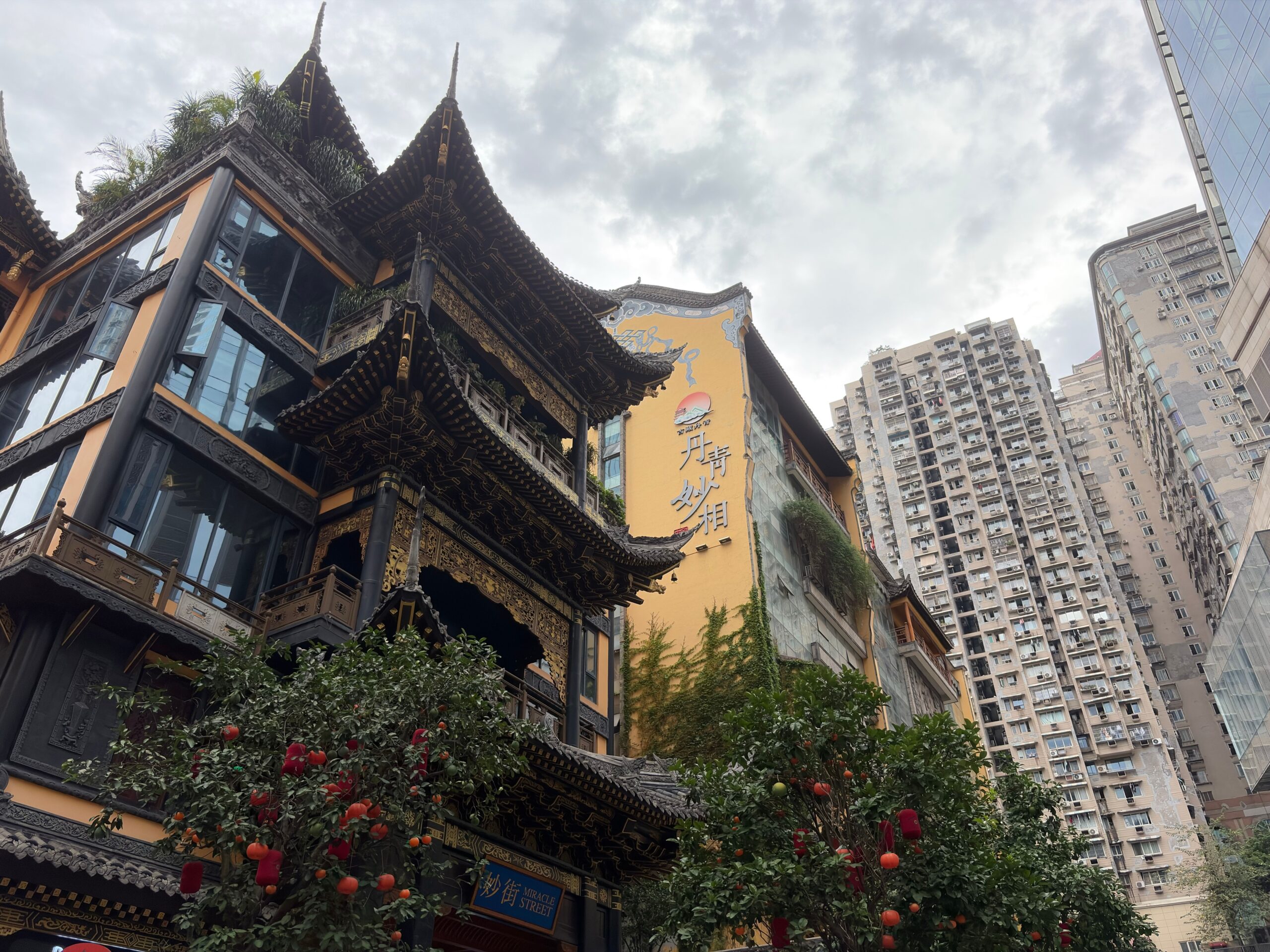 Traditional Chongqing architecture beside the city’s dense residential skyline.
