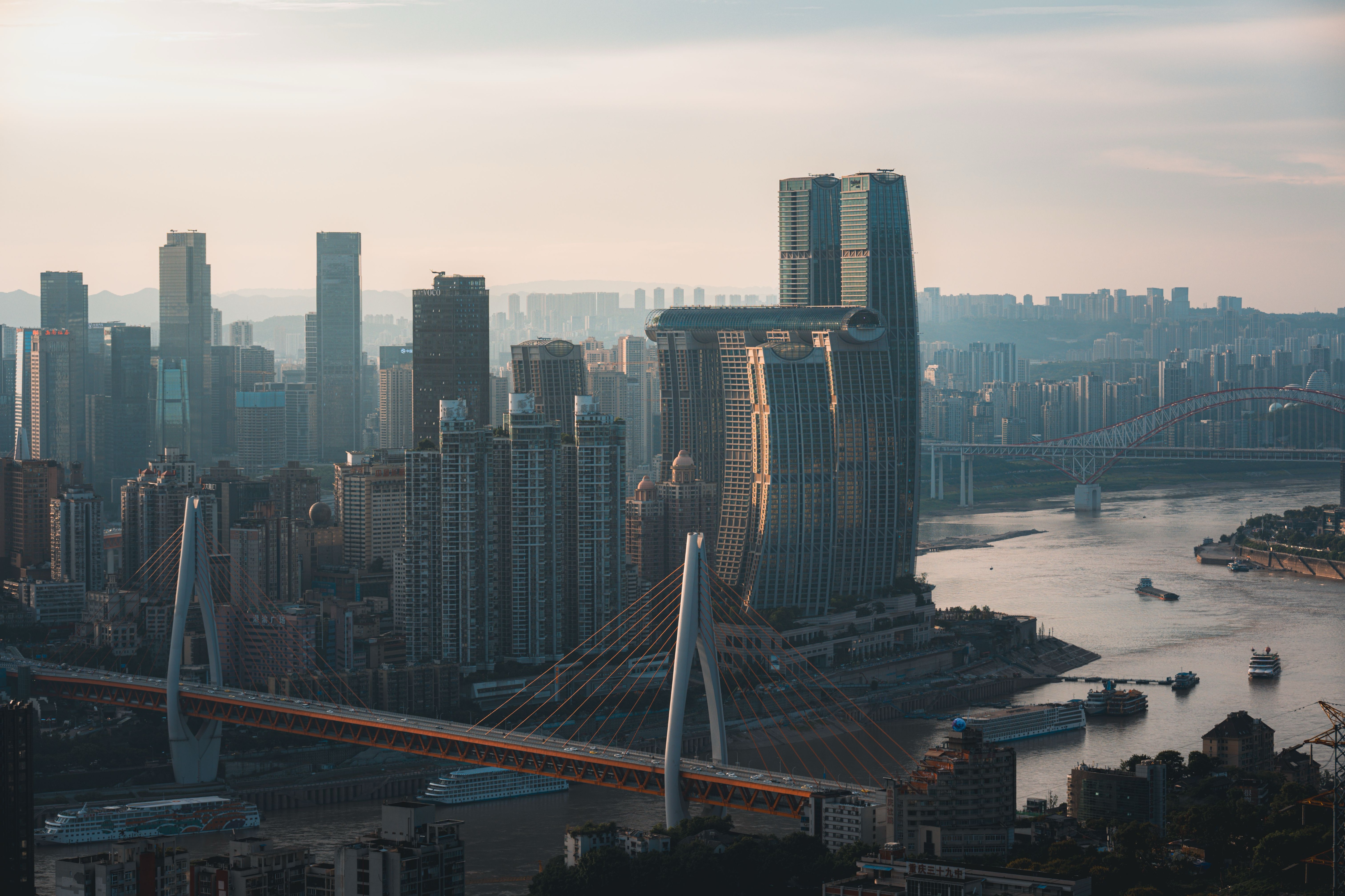 Layered view of Chongqing with Qiansimen Bridge, the river, Raffles City and the hillside skyline