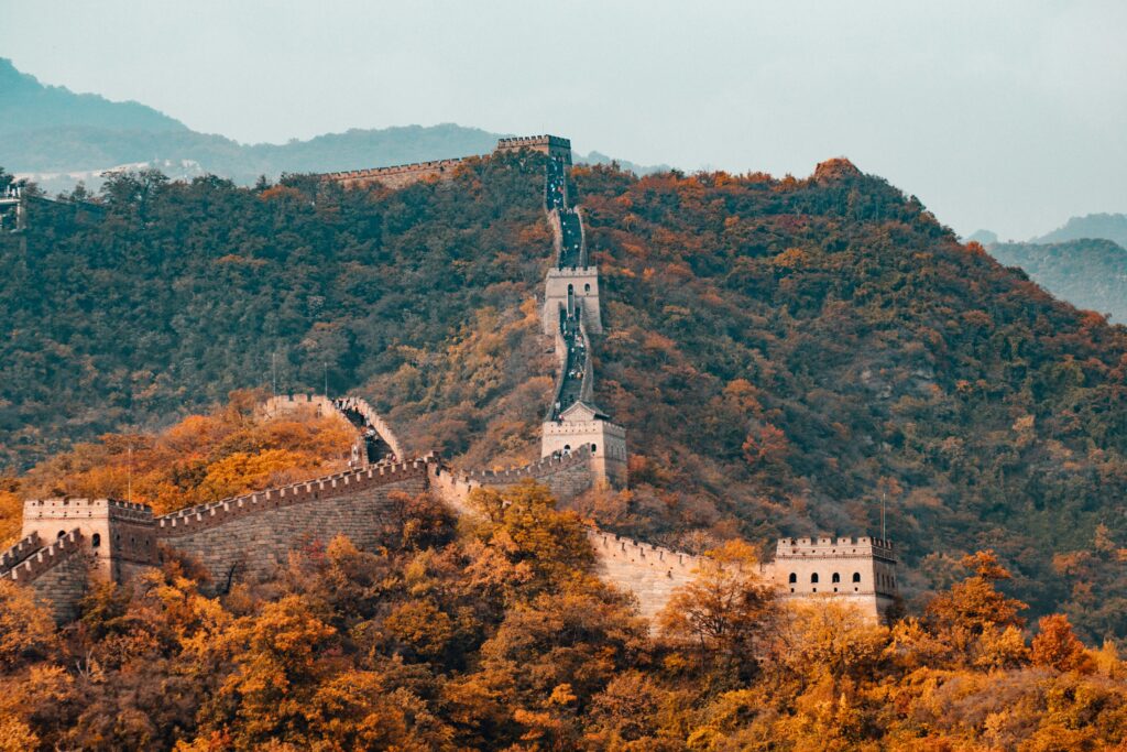 The Great Wall winding across autumn-covered mountain ridges near Beijing