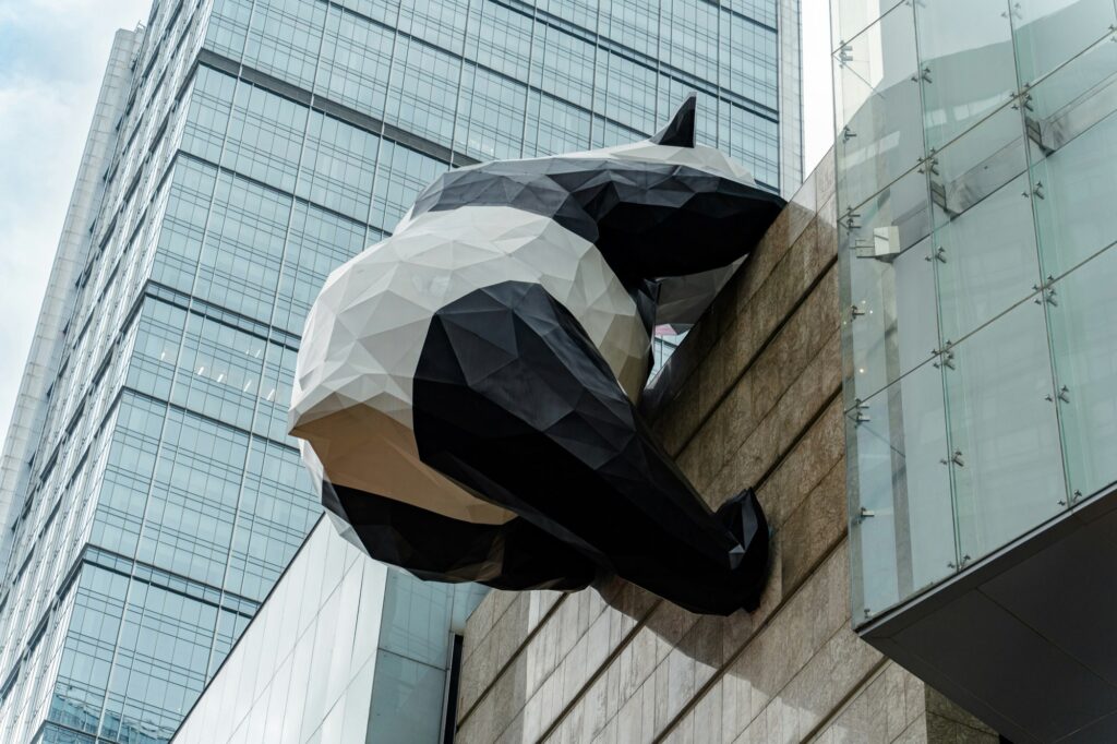 Giant panda sculpture climbing a modern building in Chengdu