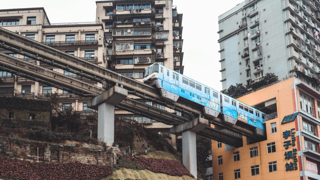Chongqing monorail passing between hillside apartment buildings