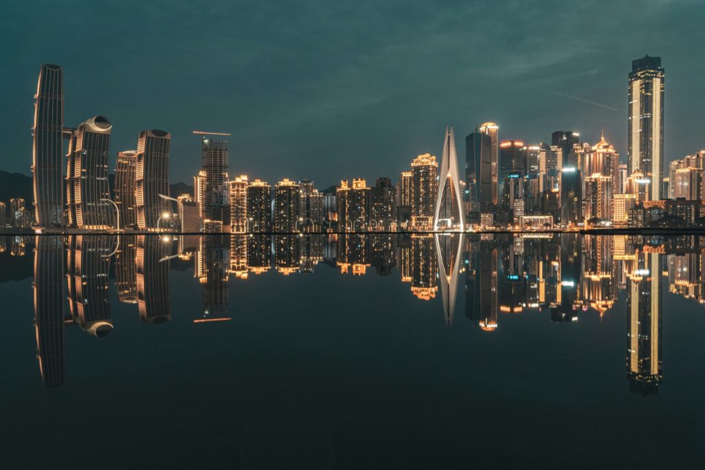 Illuminated Chongqing skyline reflected across the river at night